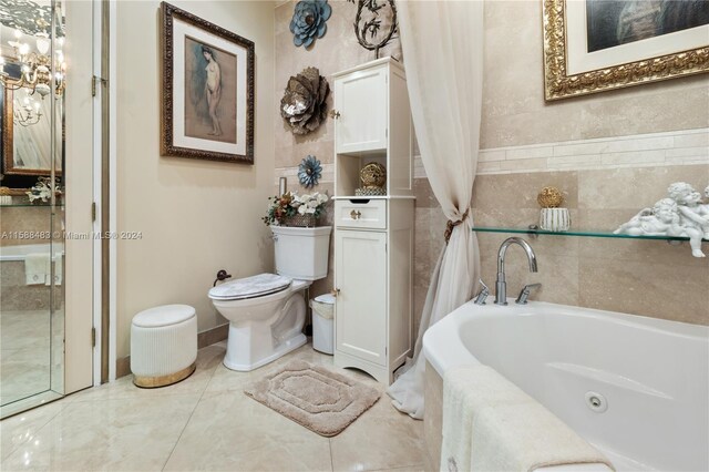 bathroom with tile floors, a bath to relax in, toilet, and vanity