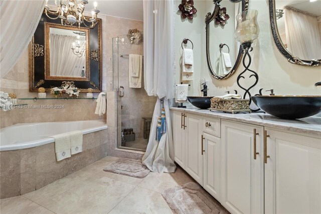 bathroom featuring a notable chandelier, tile flooring, separate shower and tub, and vanity