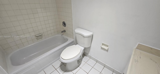 bathroom with toilet, tiled shower / bath combo, and tile patterned floors