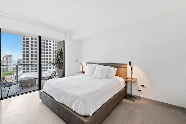 bedroom featuring a wall of windows and access to outside