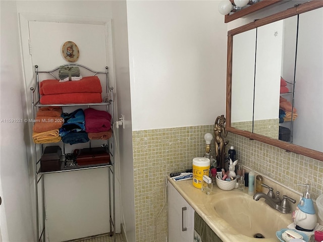 bathroom featuring tile walls, backsplash, and vanity