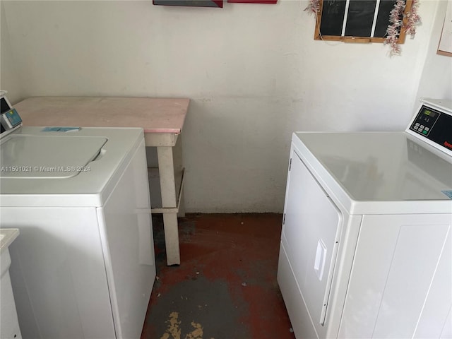 clothes washing area with separate washer and dryer