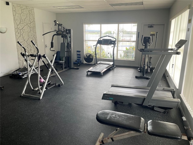 exercise room featuring a drop ceiling