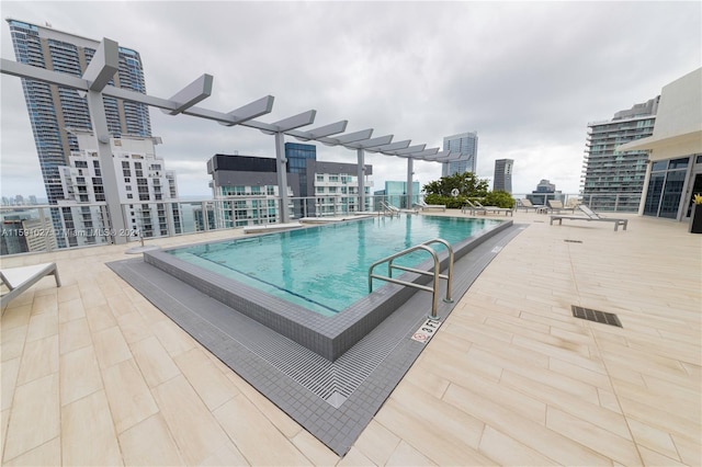 view of swimming pool featuring a pergola