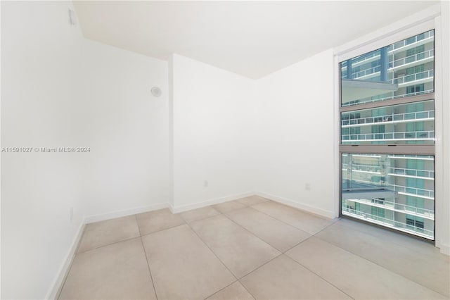 tiled spare room with plenty of natural light