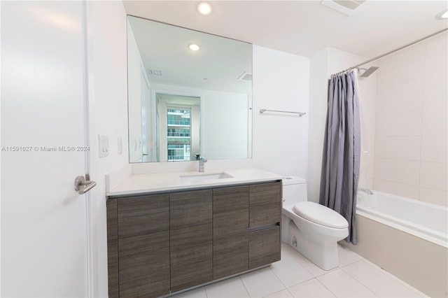 full bathroom featuring vanity, toilet, tile patterned flooring, and shower / bath combo