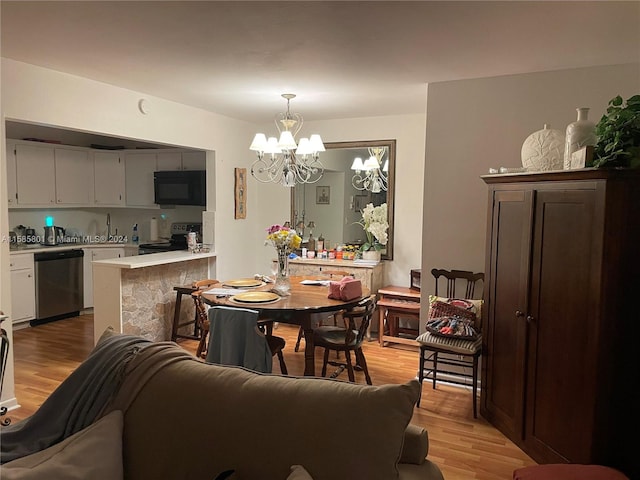 dining room featuring a notable chandelier and light wood-type flooring