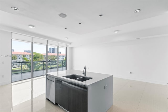 kitchen featuring an island with sink, sink, light tile floors, and stainless steel dishwasher