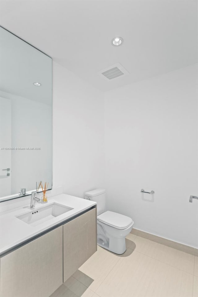 bathroom featuring toilet, recessed lighting, visible vents, and vanity
