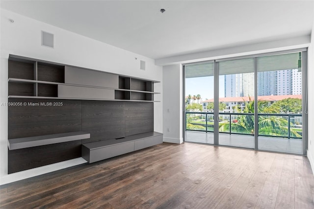 unfurnished living room featuring wood finished floors
