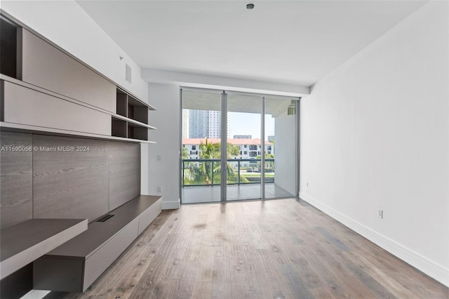 interior space with floor to ceiling windows and light wood-type flooring