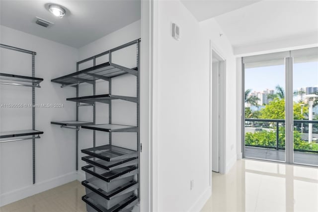 spacious closet with light tile flooring