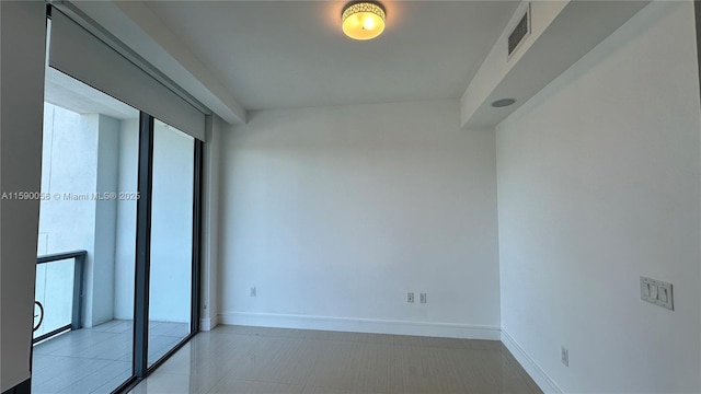 unfurnished room featuring visible vents and baseboards