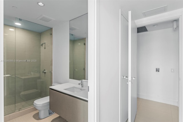 bathroom featuring tile patterned flooring, toilet, vanity, visible vents, and a stall shower