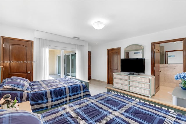 bedroom featuring light tile patterned floors, ensuite bath, and access to outside