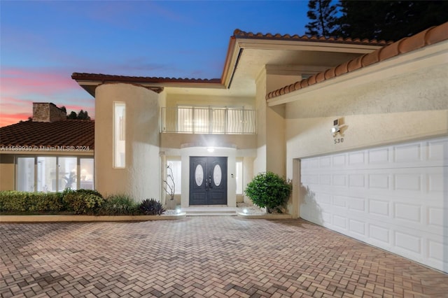 exterior space featuring a balcony and a garage