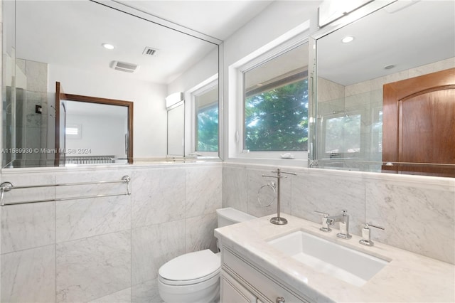 bathroom with vanity, tile walls, an enclosed shower, and toilet