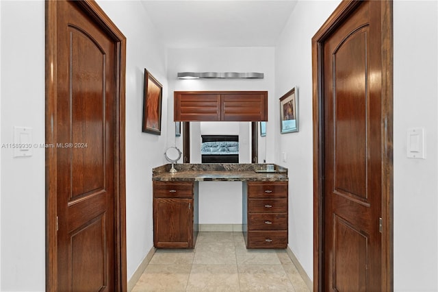 interior space with vanity and tile patterned flooring