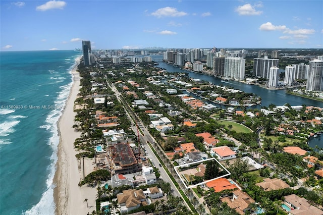 drone / aerial view with a beach view and a water view