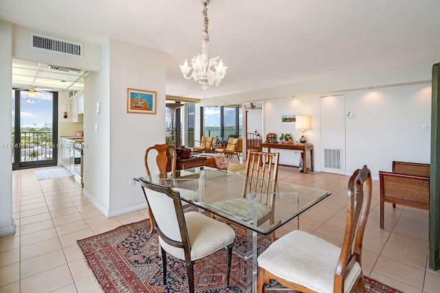 tiled dining area with an inviting chandelier