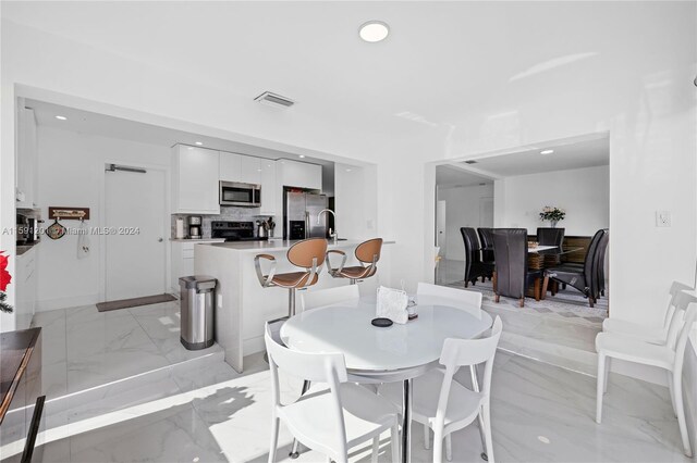 dining area with light tile patterned floors