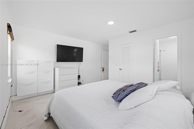 bedroom with light tile patterned floors