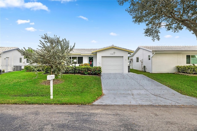 single story home with a front yard and a garage