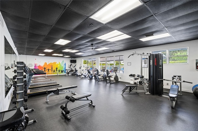 exercise room featuring a drop ceiling and a wealth of natural light