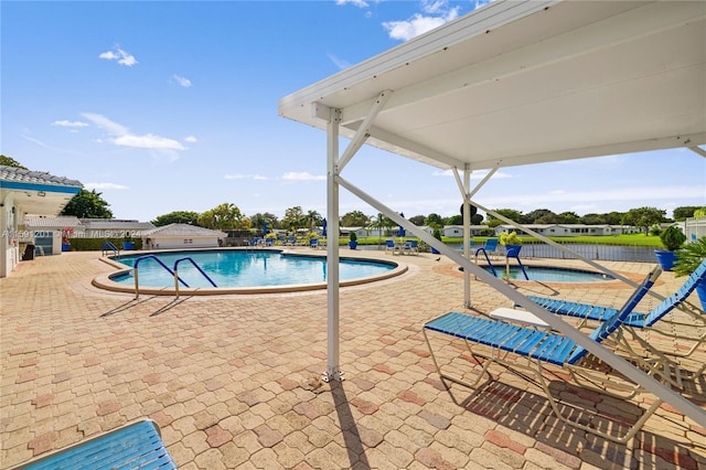 view of swimming pool with a patio area