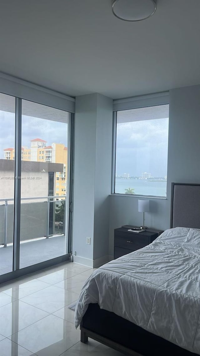 tiled bedroom with expansive windows