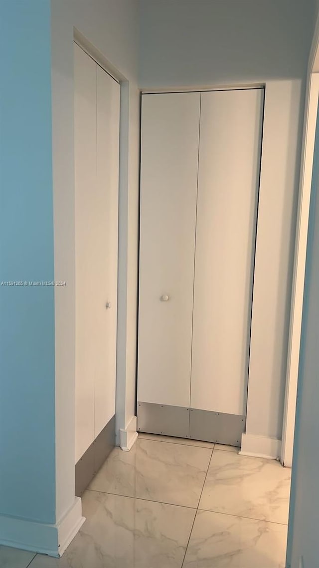 hall with light tile flooring