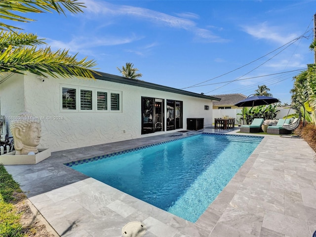 view of swimming pool with a patio