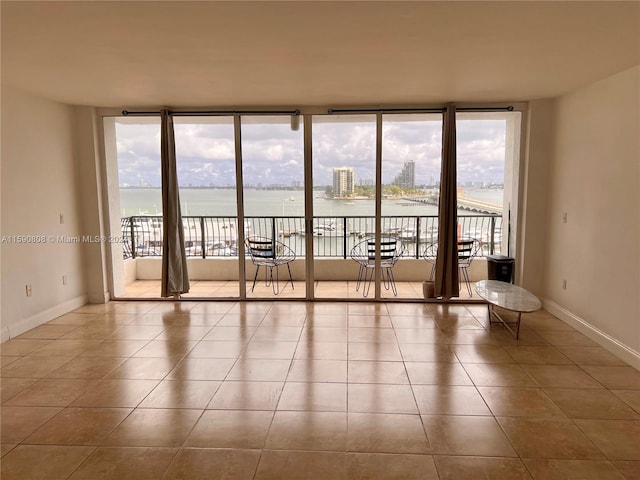 unfurnished room featuring expansive windows and tile floors