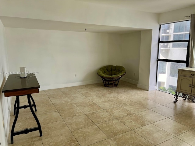 unfurnished room with light tile floors