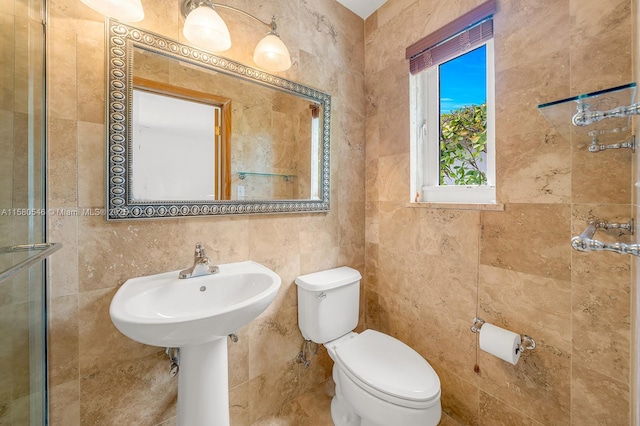 bathroom with tile walls and toilet