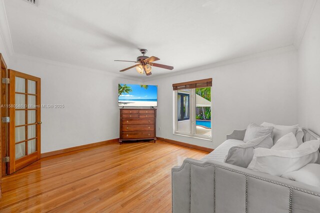 living room featuring ceiling fan, ornamental molding, and hardwood / wood-style floors