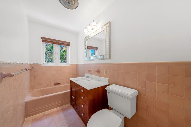 bathroom featuring tile walls, a bathtub, tile patterned flooring, and toilet