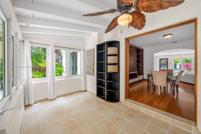 dining room featuring ceiling fan, plenty of natural light, wood ceiling, and beam ceiling