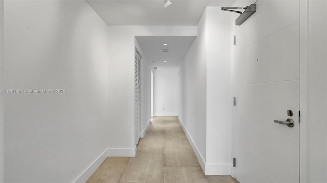 corridor with light hardwood / wood-style floors