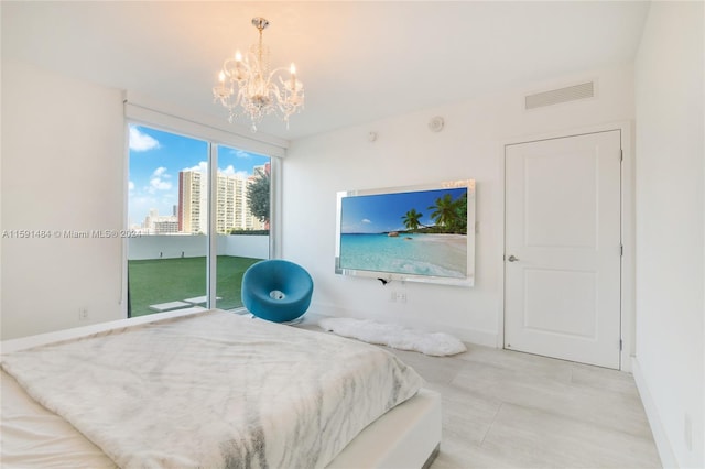 bedroom with a chandelier and access to exterior