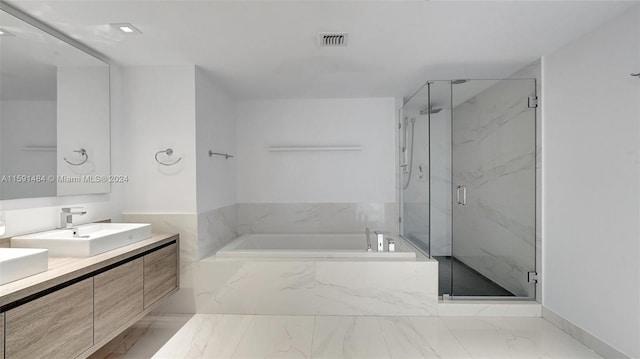 bathroom featuring vanity and shower with separate bathtub