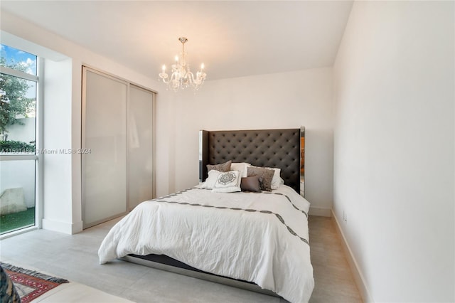 bedroom featuring a closet and a notable chandelier