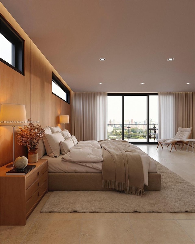 bedroom featuring wood walls and access to exterior