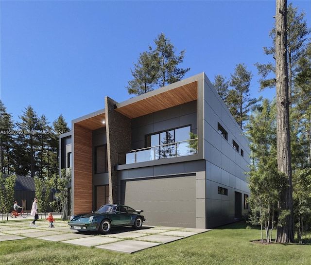 view of front of house with a garage and a front lawn