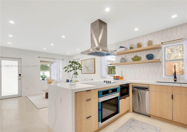 kitchen featuring light brown cabinetry, sink, island exhaust hood, kitchen peninsula, and stainless steel appliances