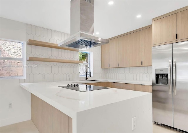 kitchen with sink, stainless steel refrigerator with ice dispenser, black electric stovetop, island range hood, and light brown cabinetry