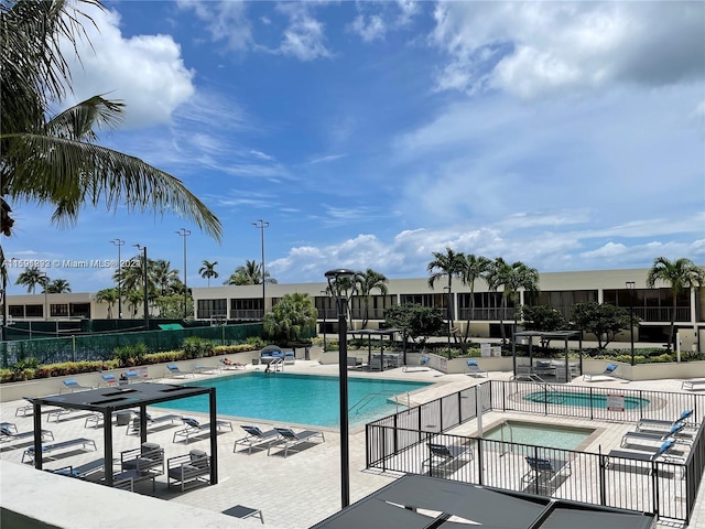 view of pool with a patio and a community hot tub