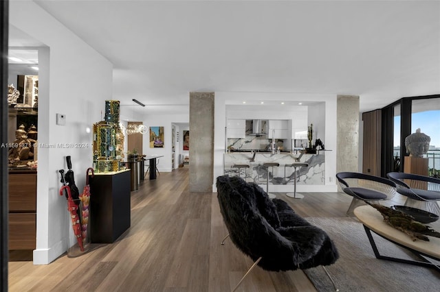 living room with an inviting chandelier and wood-type flooring