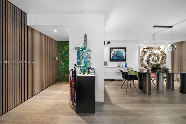 interior space featuring decorative light fixtures and light wood-type flooring