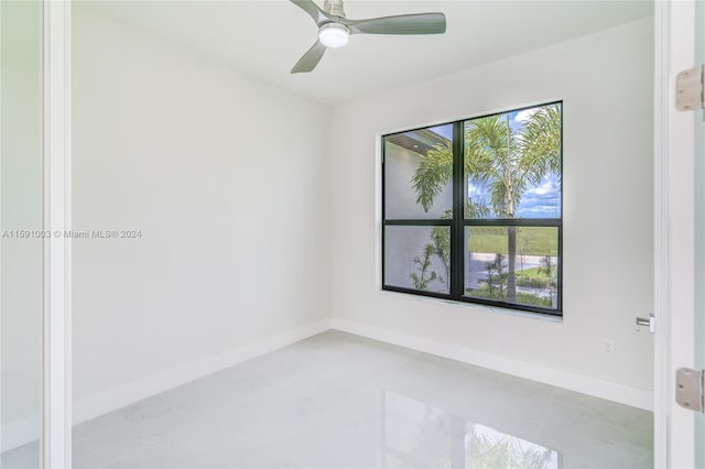 spare room with tile patterned flooring and ceiling fan